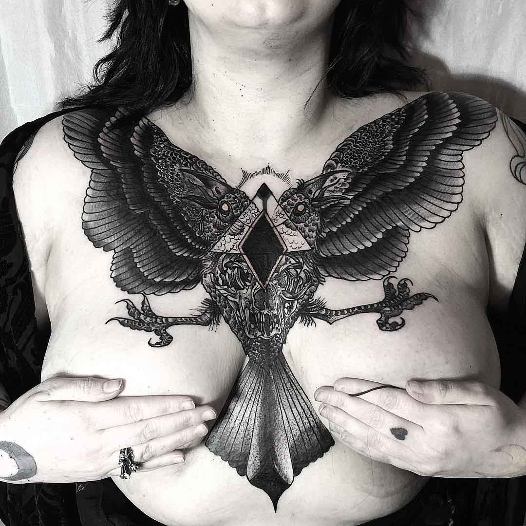 big crow tattoo on girl's chest
