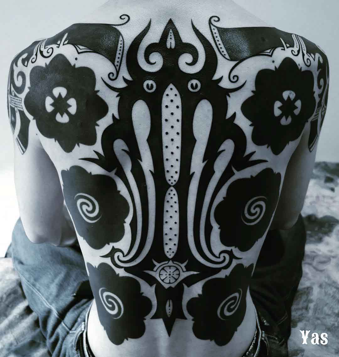 interesting blackwork tattoo on back