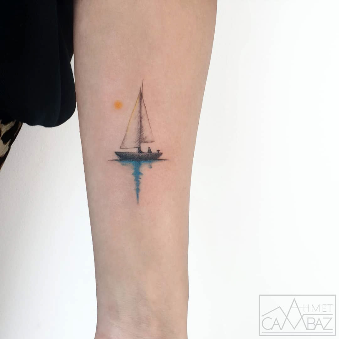 small ship tattoo on arm