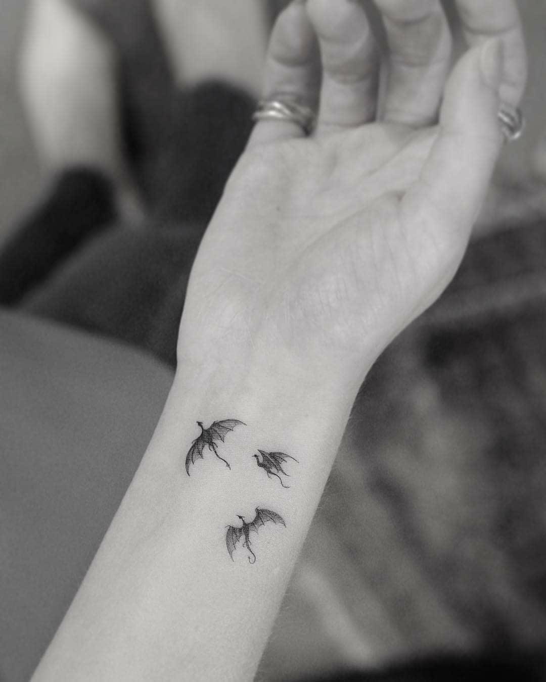 wrist tattoo dragons